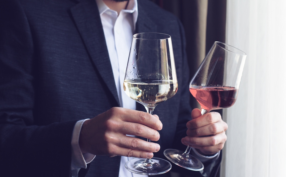 wine glasses man offering two tall glasses with wine